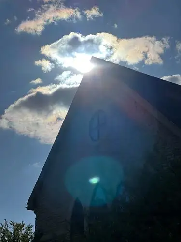 Dazzling sunburst paints the sky and structure.